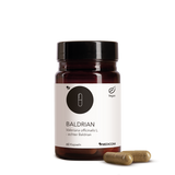 Die Produktdose von Baldrian  mit zwei Kapseln im Vordergrund