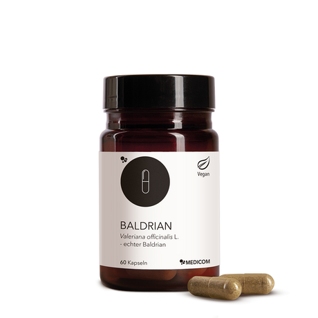Die Produktdose von Baldrian  mit zwei Kapseln im Vordergrund