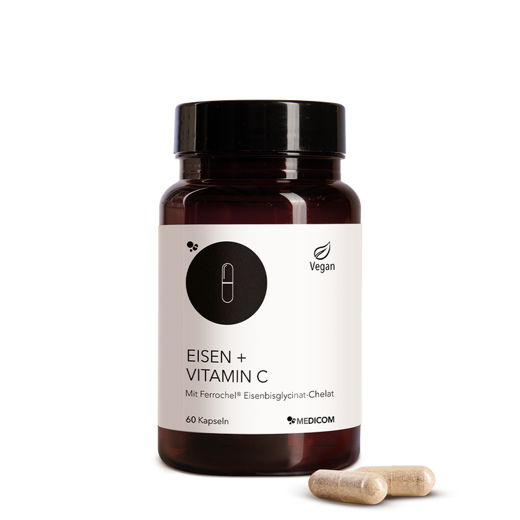 Die Produktdose von Eisen + Vitamin C und zwei Kapseln im Vordergrund