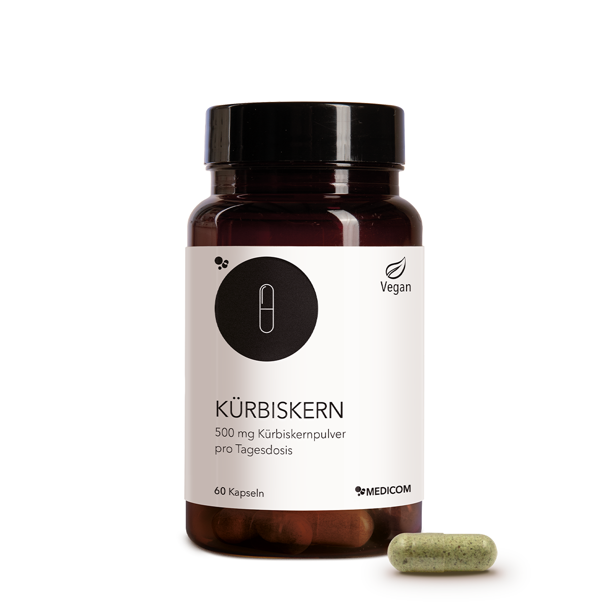 Die Kürbiskern-Produktdose von Medicom in der Vorderansicht und eine Kapsel Kürbiskernpulver im Vordergrund