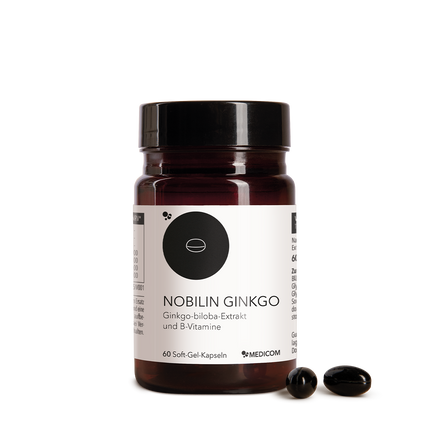 Die Produktdose von Nobilin Ginkgo von Medicom mit zwei Kapseln im Vordergrund.