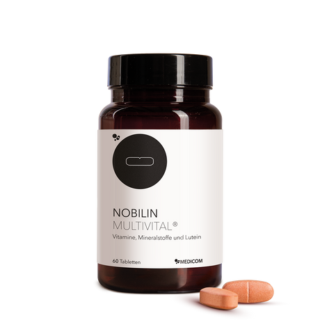 Nobilin Multvital® ­­ - die Vorderansicht der Produktdose mit zwei Tabletten im Vordergrund