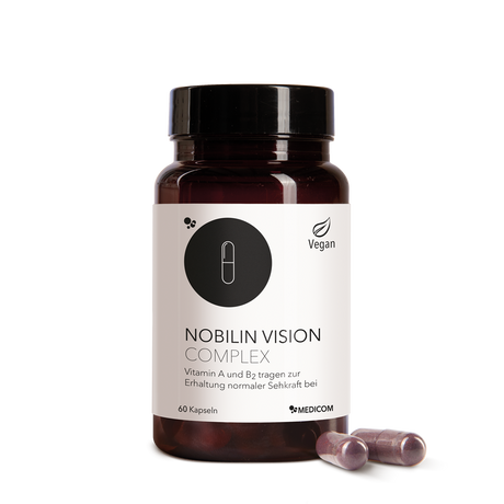 Die Produktdose von Nobilin Vision Complex mit Produktetikett und Informationen sowei zwei Kapseln im Vordergrund.