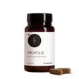 A brown bottle labeled "Propolis" with 400 mg and two Propolis capsules beside it on a white background, highlighting this valuable natural product.