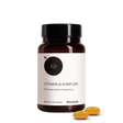 Eine Flasche Medicom Vitamin-B-Komplex mit zwei gelben Kapseln daneben auf weißem Hintergrund – für ein gesundes Nervensystem.