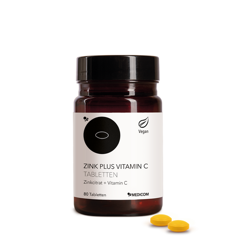 Die Zink Plus Vitamin C Tabletten  in der stilvollen Produktdose von Medicom – Zinkcitrat und Vitamin C. Zwei Tabletten im Vordergrund
